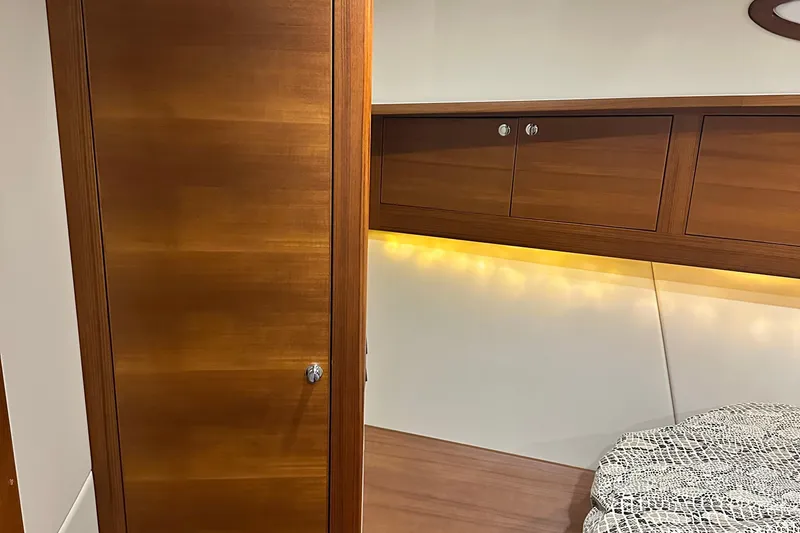 Slide: The Image of Luxurious wooden interior of 2017 Palm Beach PB42 yacht cabin with ambient lighting. - 31