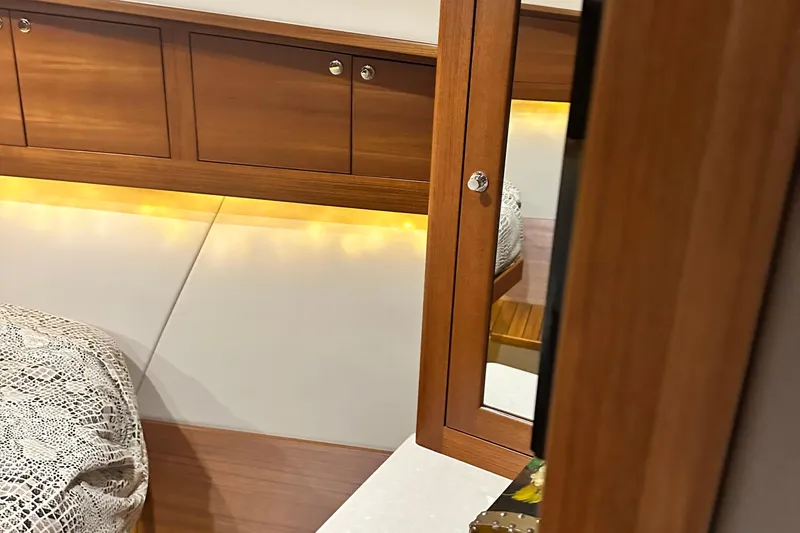 Slide: The Image of Luxurious 2017 Palm Beach PB42 yacht interior with wood cabinetry and ambient lighting. - 32