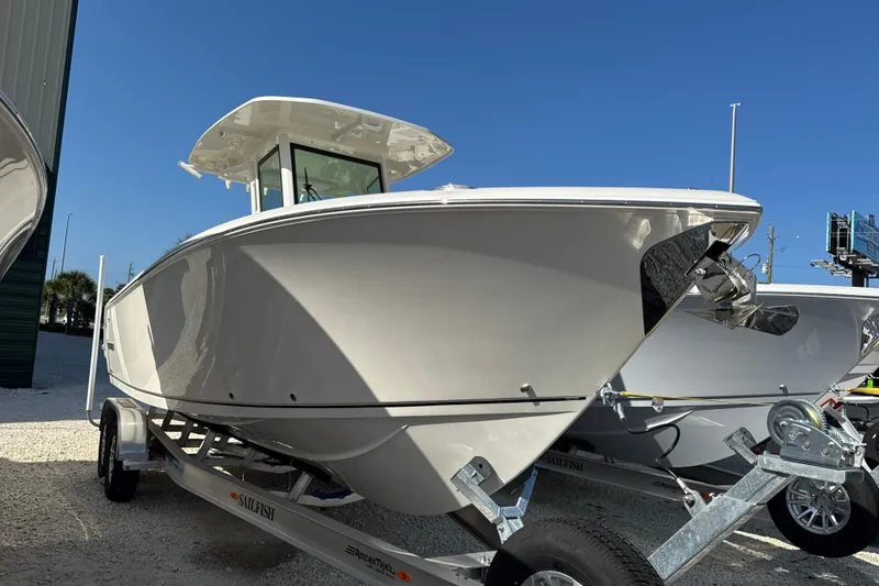 The Image of 2026 Sailfish 272 CC boat on trailer under clear blue sky. - 1