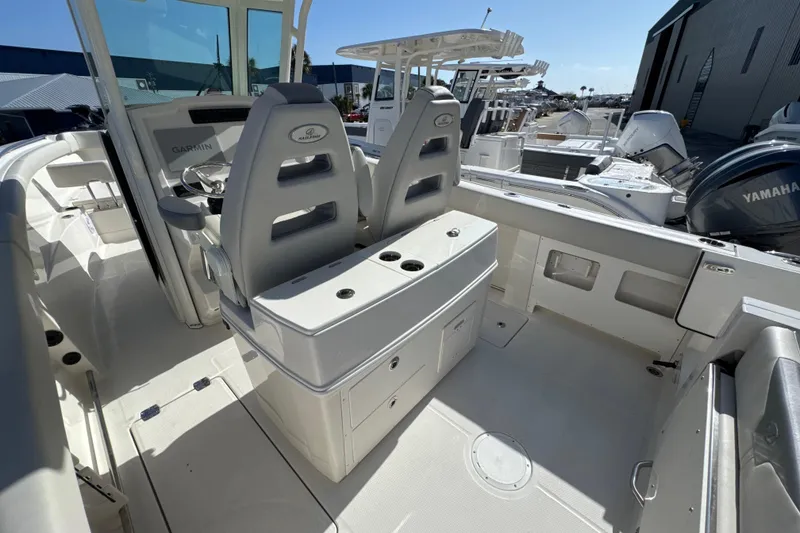 Slide: The Image of 2026 Sailfish 272 CC boat interior with dual seats, Garmin controls, and Yamaha engine. - 10