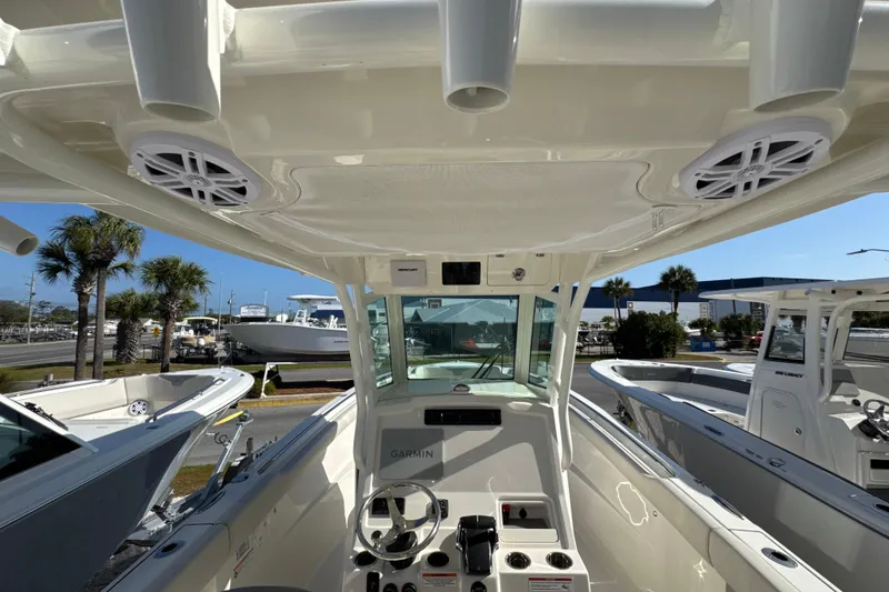 Slide: The Image of 2026 Sailfish 272 CC boat interior with steering console and overhead speakers. - 13