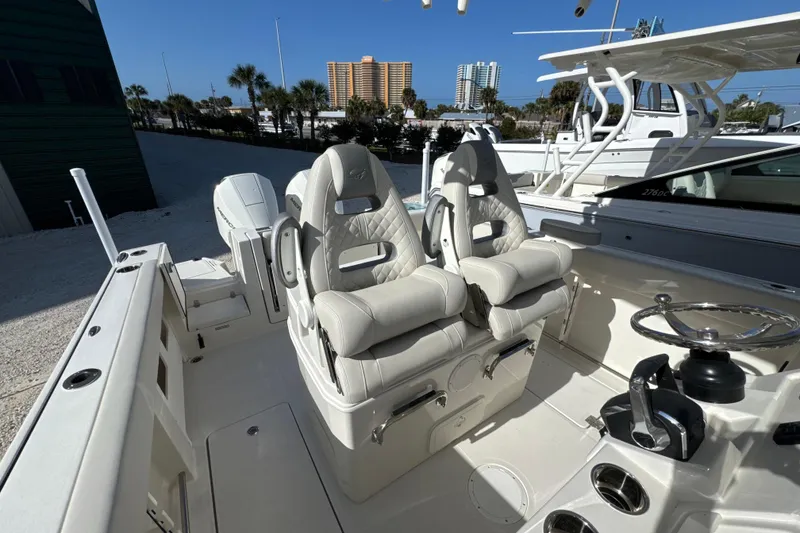 Slide: The Image of 2026 Sailfish 272 CC boat interior with luxurious seating and modern steering console. - 14