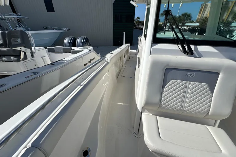 Slide: The Image of 2026 Sailfish 272 CC boat interior with white seating and sleek design. - 15