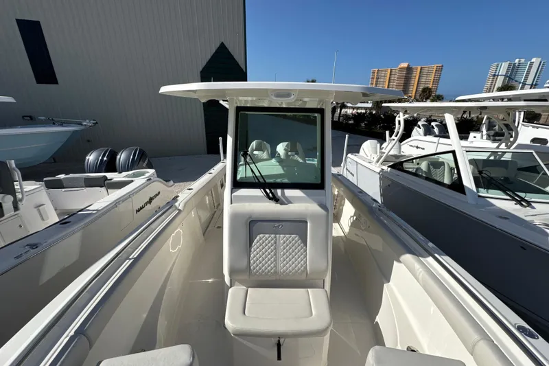 Slide: The Image of 2026 Sailfish 272 CC boat with sleek design, docked alongside similar vessels. - 18