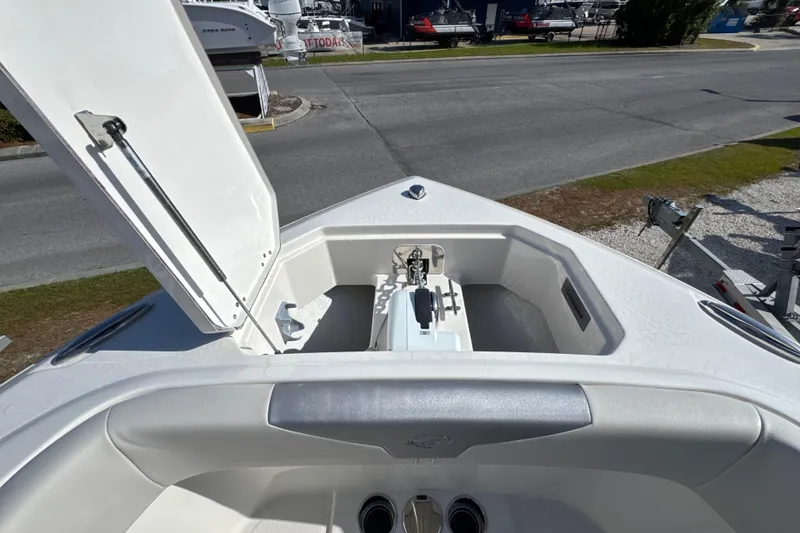 Slide: The Image of 2026 Sailfish 272 CC boat bow with open storage compartment, parked on a trailer. - 21