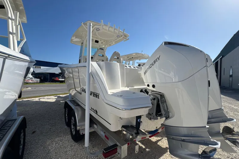 Slide: The Image of 2026 Sailfish 272 CC boat with dual Mercury engines on a trailer, sunny day. - 5