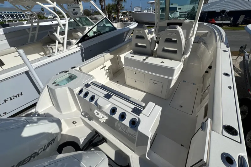 Slide: The Image of 2026 Sailfish 272 CC boat interior with dual seats, storage, and Mercury engine. - 8