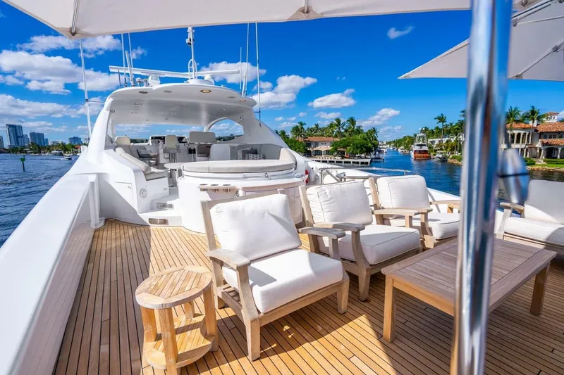 Slide: The Image of Luxurious 2008 Lazzara motor yacht with elegant deck seating and scenic waterfront view. - 61