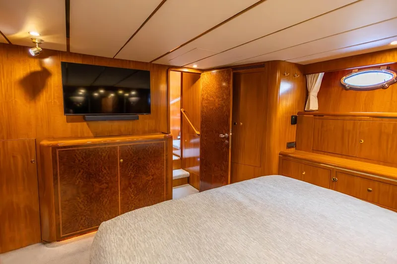 Slide: The Image of Luxurious 2005 Ocean Alexander yacht bedroom with wood paneling and mounted TV. - 14