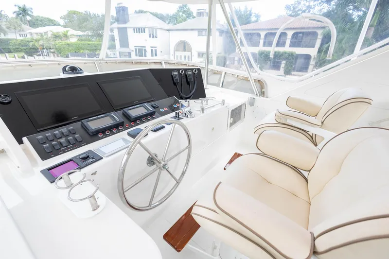Slide: The Image of 2005 Ocean Alexander Raised Pilothouse Flybridge Sedan helm with dual seats and navigation controls. - 20