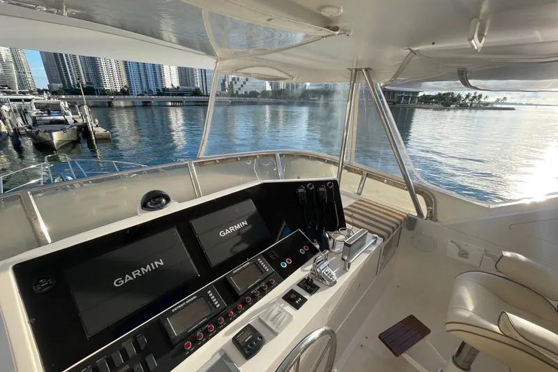 Slide: The Image of 2005 Ocean Alexander Raised Pilothouse Flybridge Sedan helm with Garmin navigation, overlooking marina. - 22