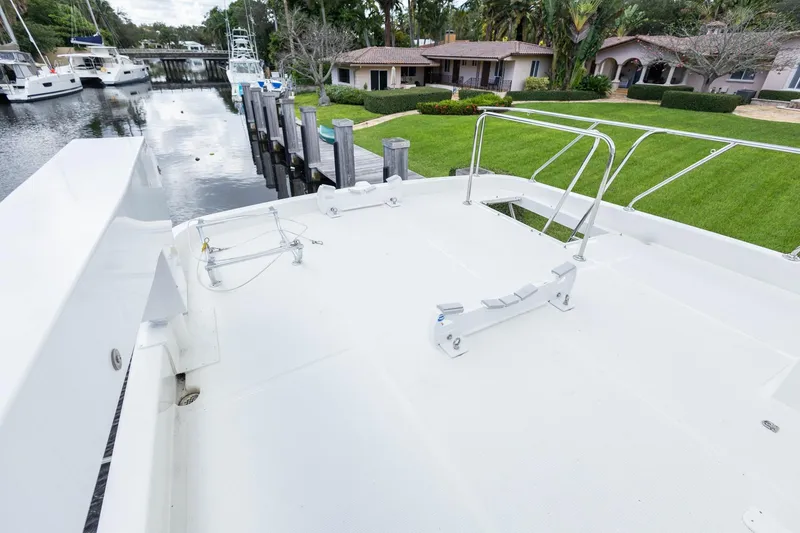 Slide: The Image of 2005 Ocean Alexander Raised Pilothouse Flybridge Sedan docked near waterfront homes. - 27