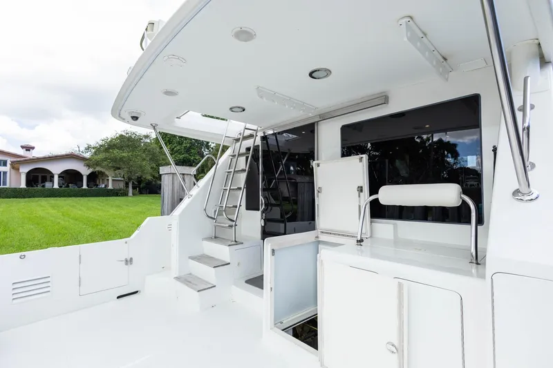 Slide: The Image of 2005 Ocean Alexander Raised Pilothouse Flybridge Sedan yacht deck with stairs and seating. - 30