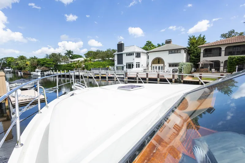 Slide: The Image of 2005 Ocean Alexander yacht docked near waterfront homes under a clear blue sky. - 33