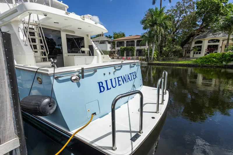 Slide: The Image of 2005 Ocean Alexander Raised Pilothouse Flybridge Sedan docked by waterfront homes. - 48
