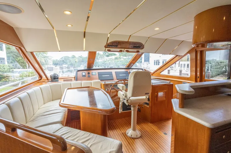 Slide: The Image of Luxurious 2005 Ocean Alexander Raised Pilothouse Flybridge Sedan interior with helm and seating area. - 8