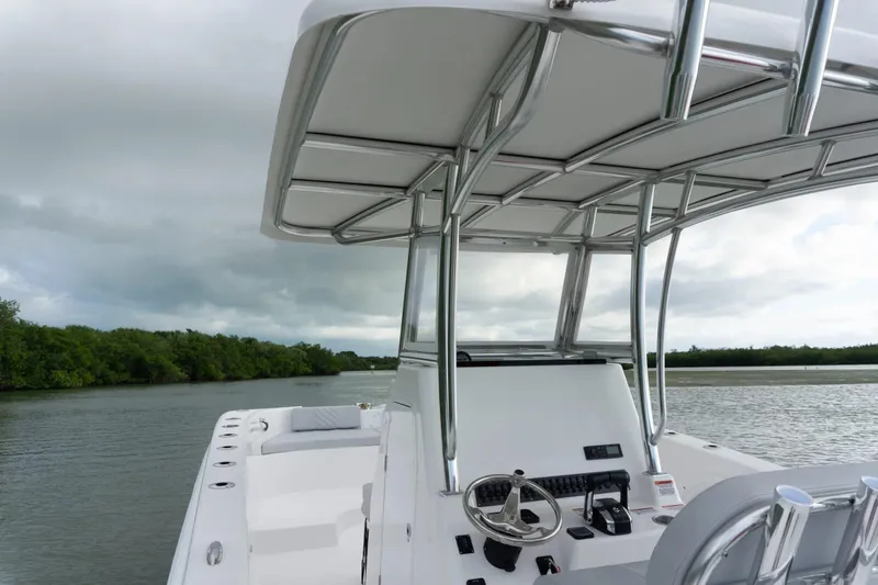 Slide: The Image of Twin Vee 280 STX CC 2026 on calm waters with cloudy sky. - 5