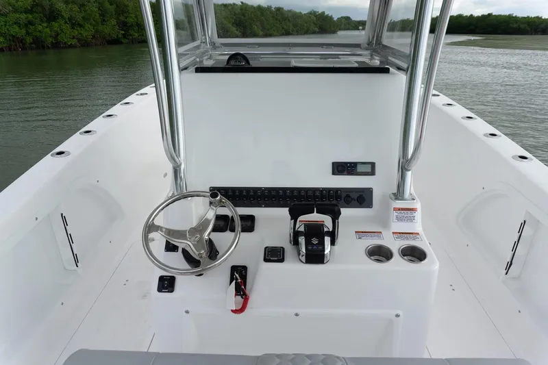 Slide: The Image of Manufacturer Provided Image: 2026 Twin Vee 280 STX CC boat console with steering wheel and controls on calm water. - 6