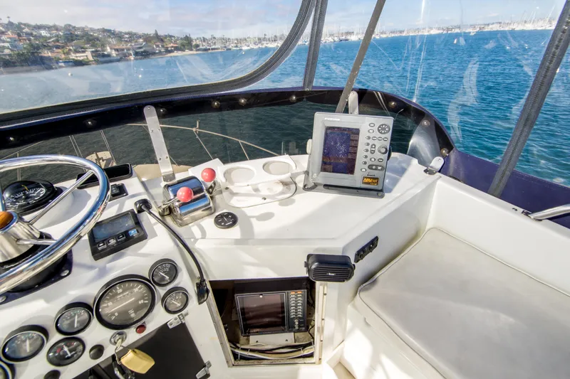 Slide: The Image of Cockpit of 1996 Blackman Sportfisher 32 with navigation equipment and ocean view. - 13