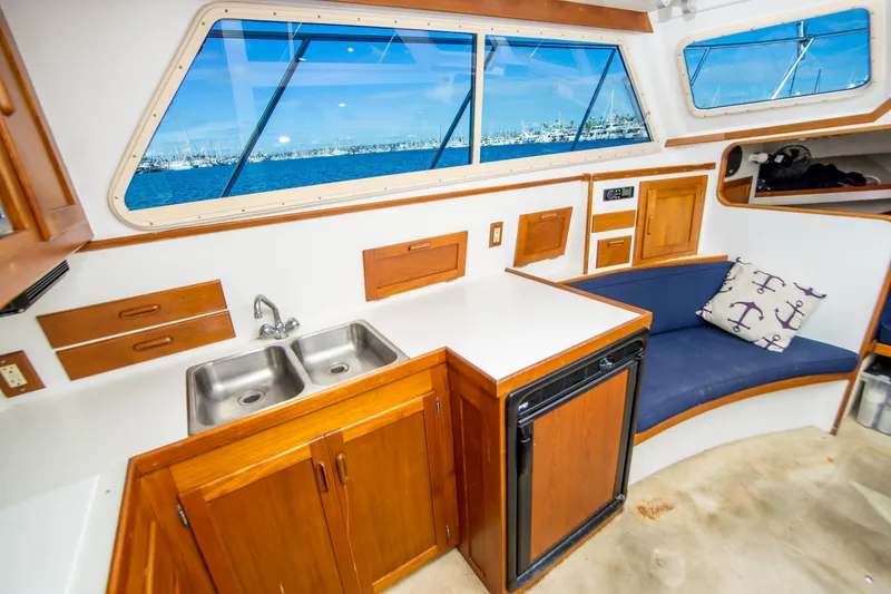 Slide: The Image of Interior of 1996 Blackman Sportfisher 32 with kitchenette and seating area. - 17