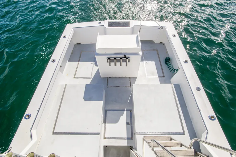 Slide: The Image of 1996 Blackman Sportfisher 32 boat deck with ocean view, featuring fishing rod holders. - 27