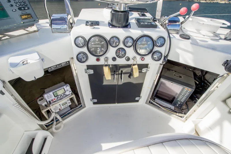 Slide: The Image of Control panel of a 1996 Blackman Sportfisher 32 boat with gauges and navigation equipment. - 8