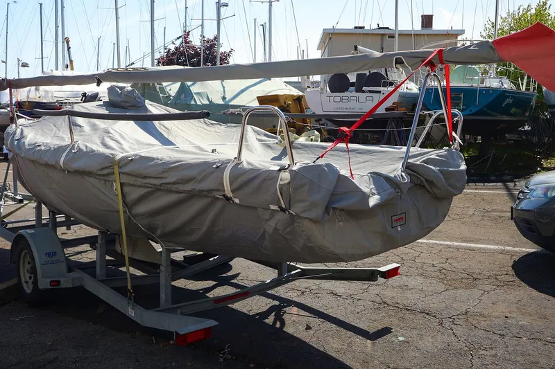Slide: The Image of Covered 2013 J Boats J/70 sailboat on trailer in marina setting. - 4