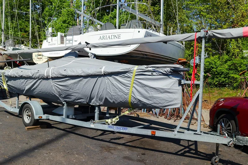 Slide: The Image of Covered 2013 J Boats J/70 sailboat on trailer, parked outdoors near other boats. - 5