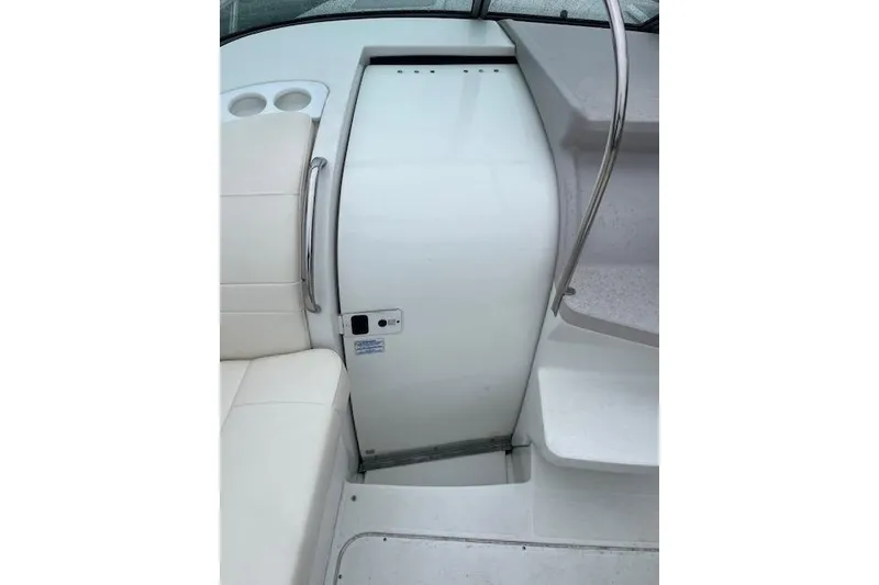 Slide: The Image of Interior view of a 2004 Formula 26 Performance Cruiser, featuring seating and cabin entrance. - 11