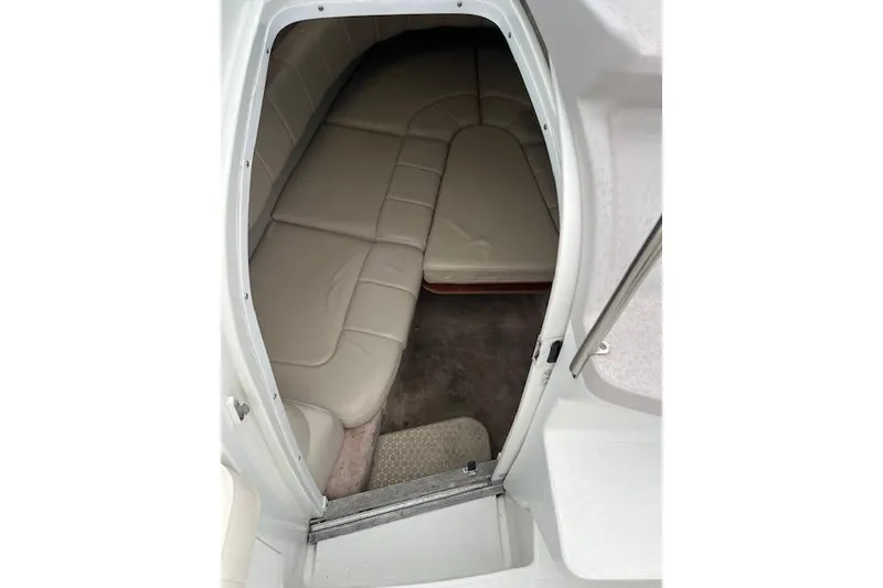 Slide: The Image of 2004 Formula 26 Performance Cruiser cabin interior with beige seating and carpeted floor. - 17