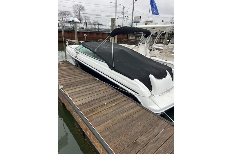Slide: The Image of 2004 Formula 26 Performance Cruiser docked with black cover, side view. - 2