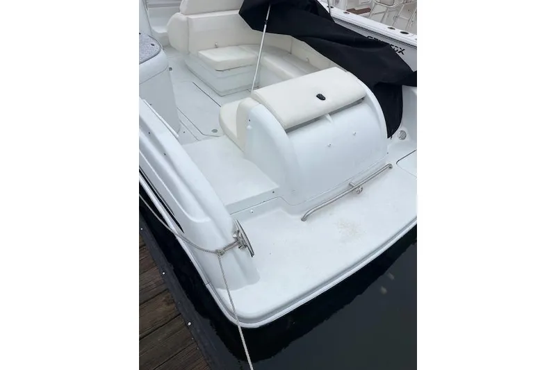 Slide: The Image of 2004 Formula 26 Performance Cruiser boat with white seating and docked at a marina. - 3