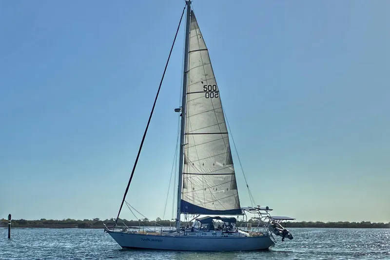 The Image of Sailboat "Custom Pinical 14-34" from 1985 on calm waters under clear sky. - 0
