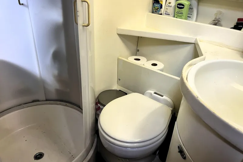 Slide: The Image of Compact bathroom in 1985 Pinical 14-34 RV with shower, toilet, and sink. - 19
