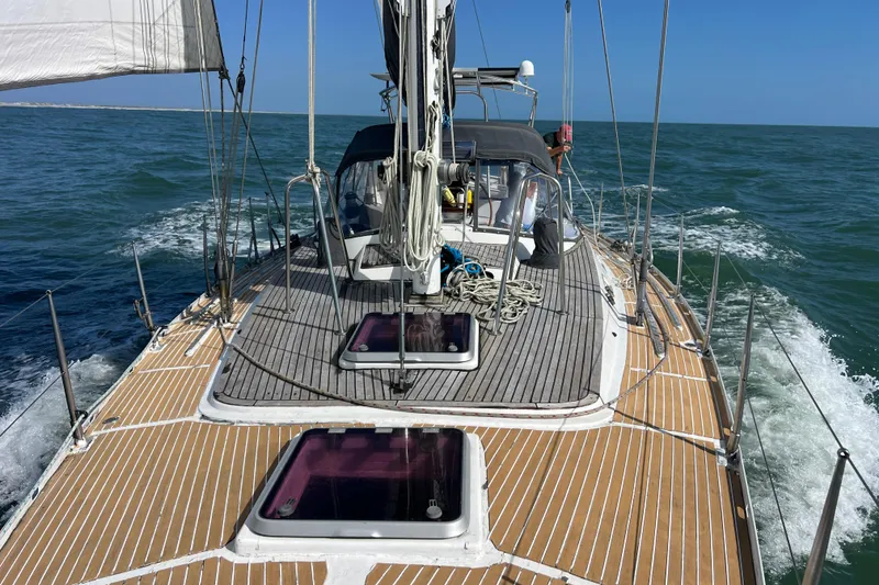 Slide: The Image of Sailing on a 1985 Pinical 14-34 yacht, navigating open waters under clear blue skies. - 2