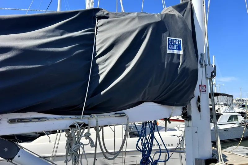 Slide: The Image of Sailboat mast with Schurr Sails cover, Pinical 14-34, 1985 model, docked at marina. - 22