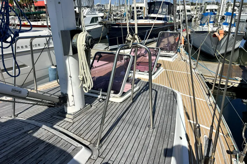 Slide: The Image of Sailboat deck view, Pinical 14-34, 1985 model, docked at marina with other boats. - 23