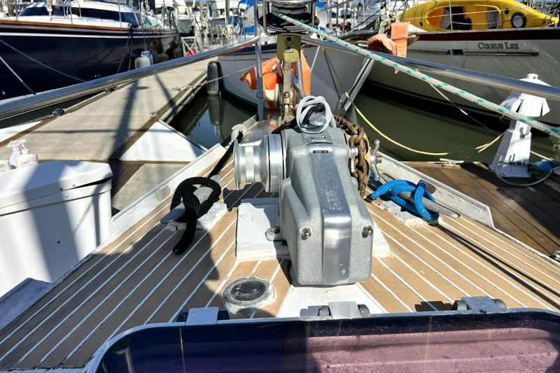 Slide: The Image of Bow of 1985 Pinical 14-34 yacht with anchor winch and ropes at marina. - 26