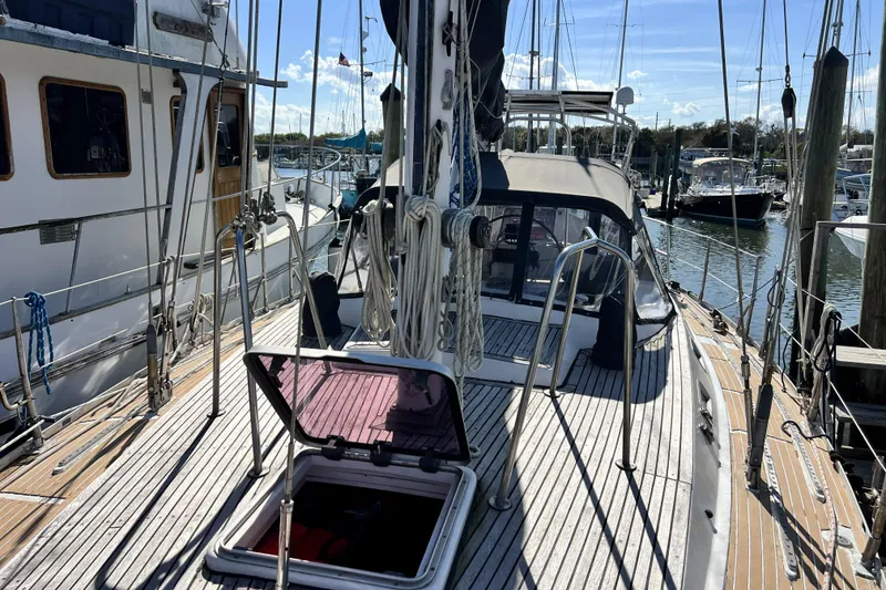 Slide: The Image of Sailboat docked at marina, Pinical 14-34 model, 1985, with open hatch and rigging. - 27