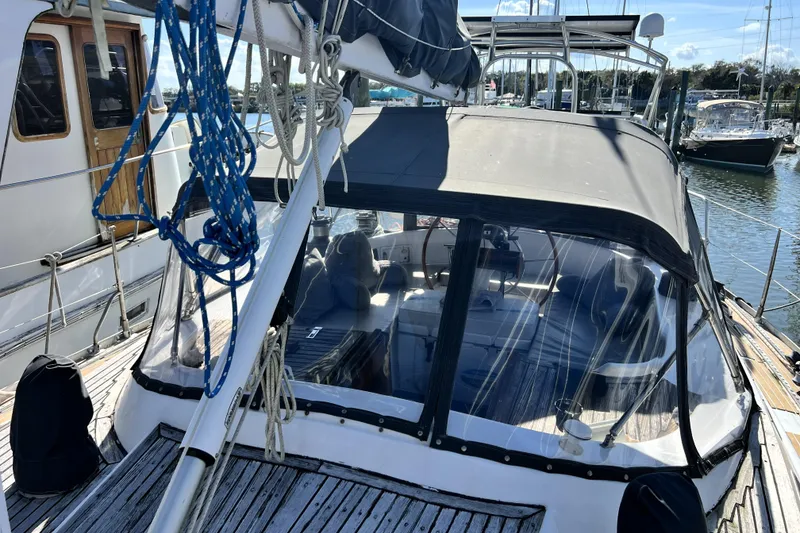 Slide: The Image of Sailboat docked at marina, featuring Pinical 14-34 model from 1985. - 28