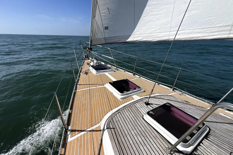 Slide: The Image of Sailing on a 1985 Pinical 14-34 yacht with wooden deck and open sea view. - 3