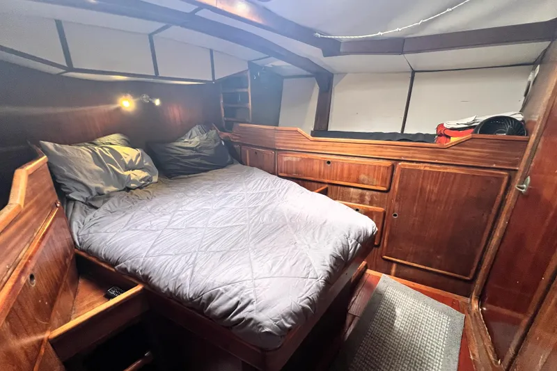 Slide: The Image of Cozy cabin interior of 1985 Custom Pinical 14-34 with wooden furnishings and bed. - 36