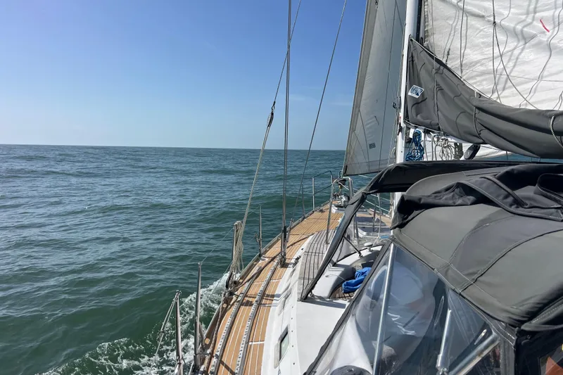 Slide: The Image of Sailing on a 1985 Pinical 14-34 yacht in open sea under clear blue skies. - 4