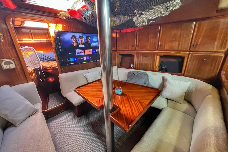 Slide: The Image of Cozy yacht interior with wooden cabinets, TV, and cushioned seating, Pinical 14-34, 1985 model. - 5