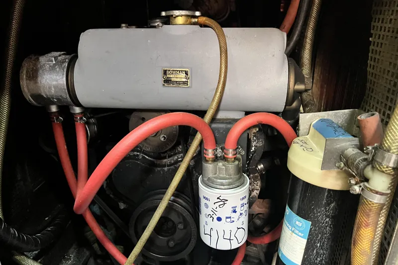 Slide: The Image of Engine compartment of a 1985 Pinical 14-34 with visible hoses and filters. - 7