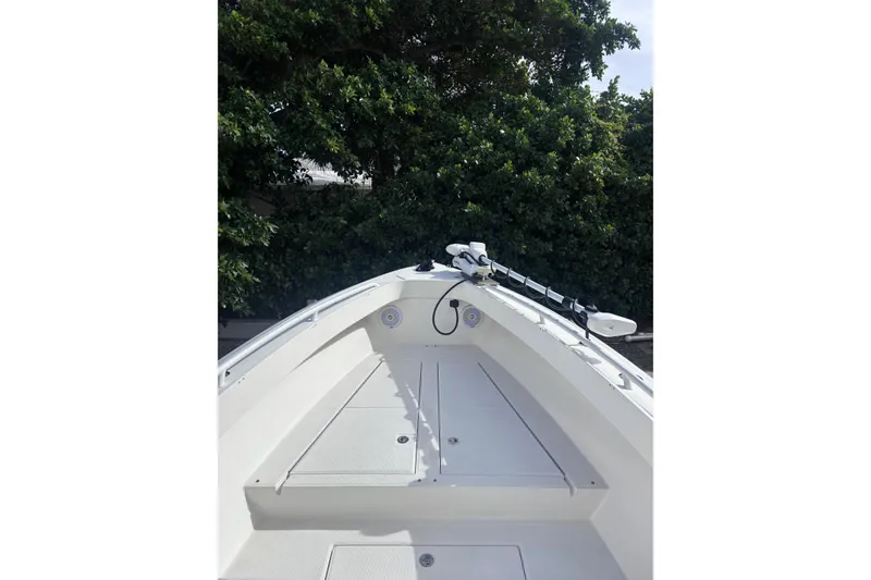 Slide: The Image of 2003 Island Runner 26 Center Console boat with lush greenery in the background. - 10