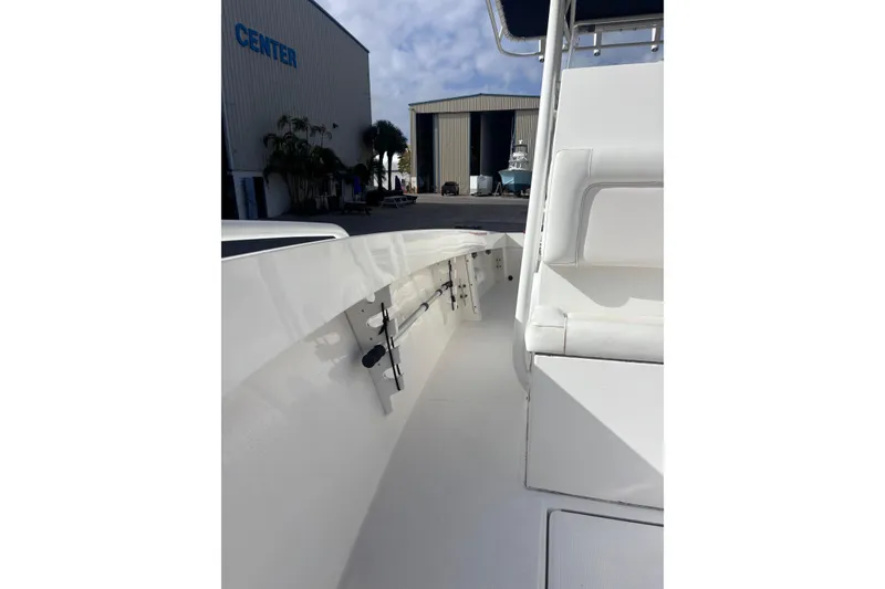 Slide: The Image of 2003 Island Runner 26 Center Console boat docked near a warehouse. - 12