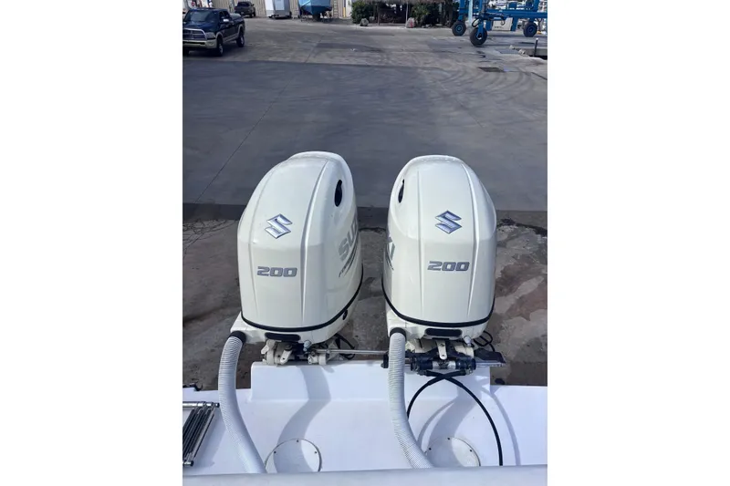 Slide: The Image of Twin Suzuki 200 outboard engines on a 2003 Island Runner 26 Center Console boat. - 15