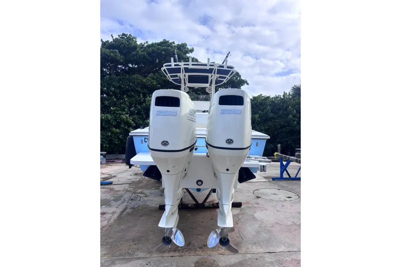 Slide: The Image of 2003 Island Runner 26 Center Console with twin outboard engines on a concrete surface. - 18