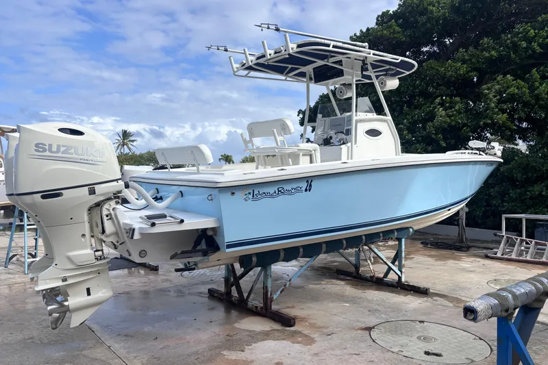 Slide: The Image of 2003 Island Runner 26 Center Console boat with Suzuki outboard motor on a stand. - 3